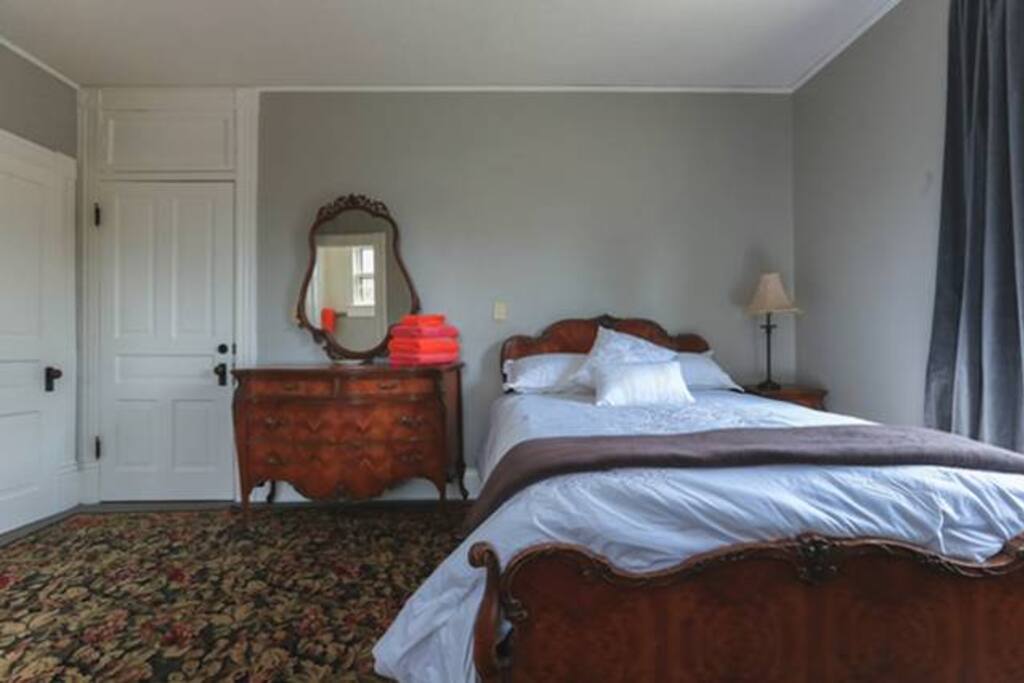 Doris Room, full size antique bed, high count cotton sheets, east and south windows.