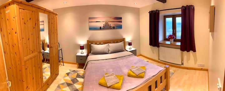 The main bedroom is located on the second floor, with a king size bed, illuminated paintings and ample storage