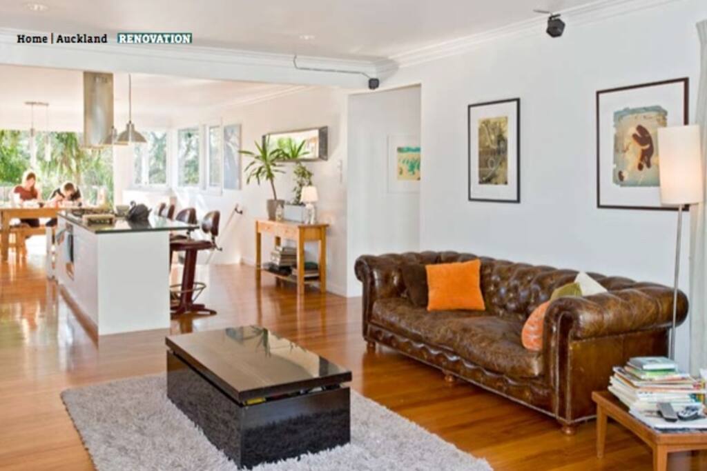 The open plan lounge / kitchen / dining room with bifold doors onto the deck