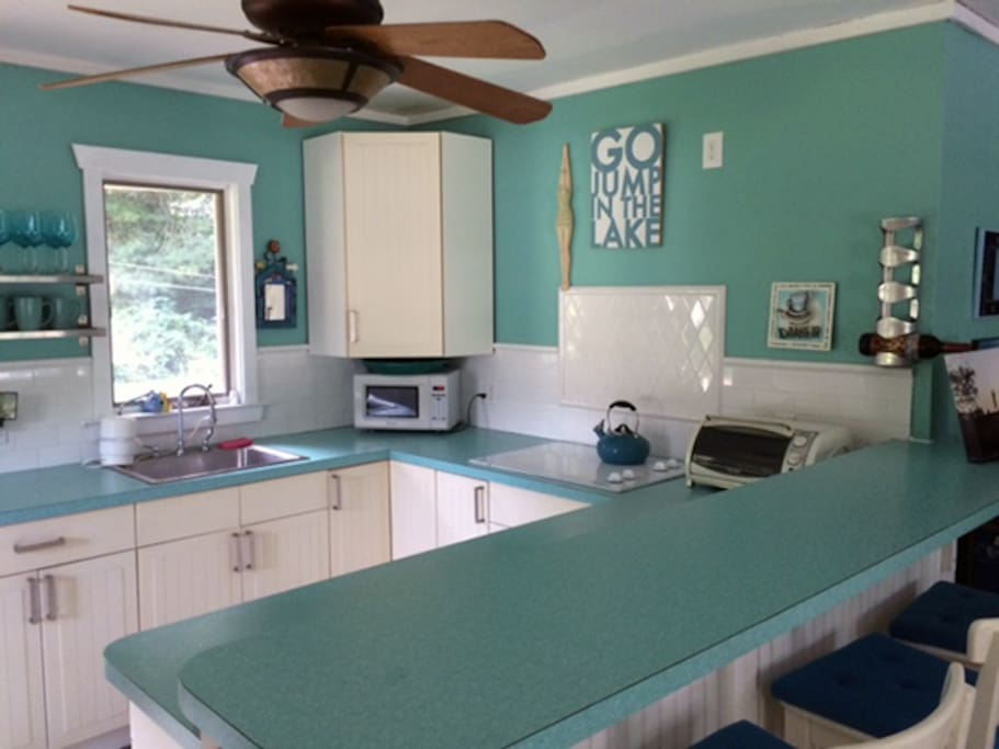 Kitchen includes a full-size fridge, cook top, toaster oven, and microwave. No oven!