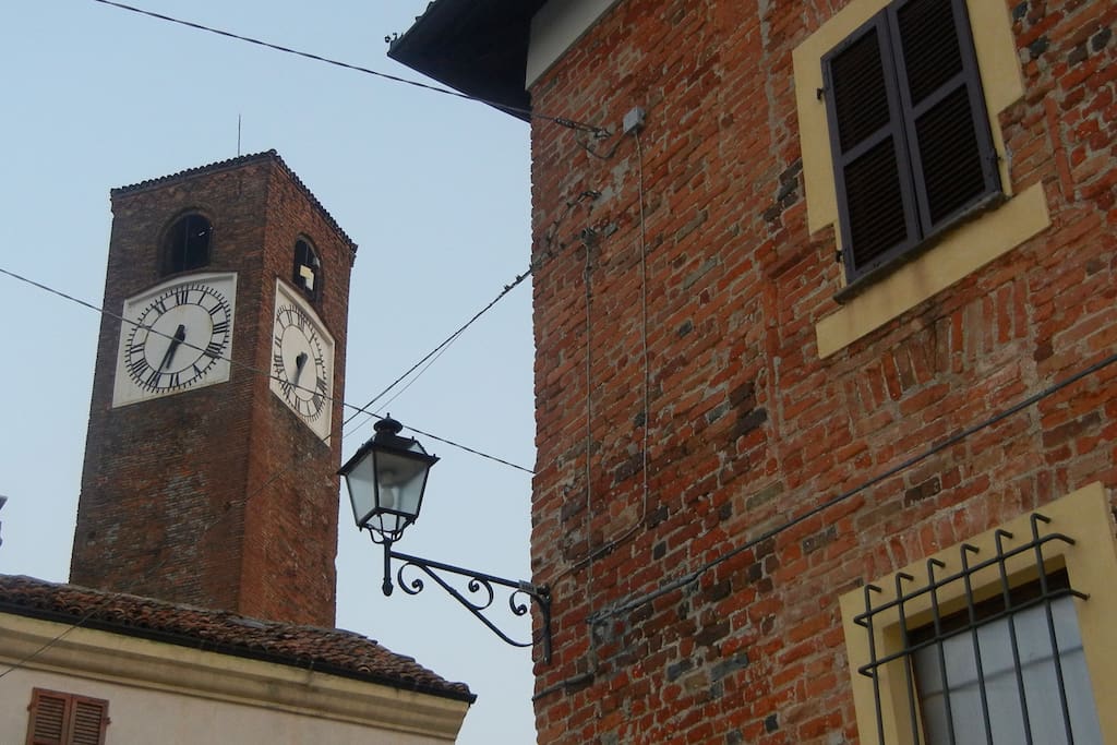 The clock tower and medieval building in the heart of Mombaruzzo