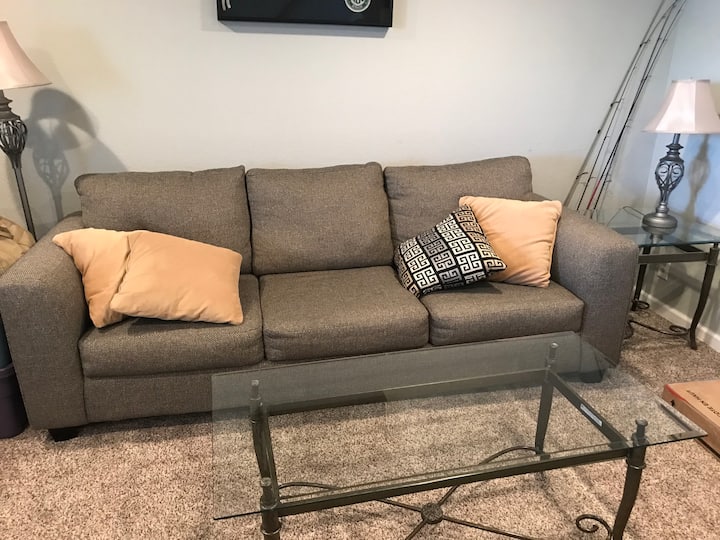 Downstairs living area with pull out couch for extra sleeping, along with a tv for separate tv time.