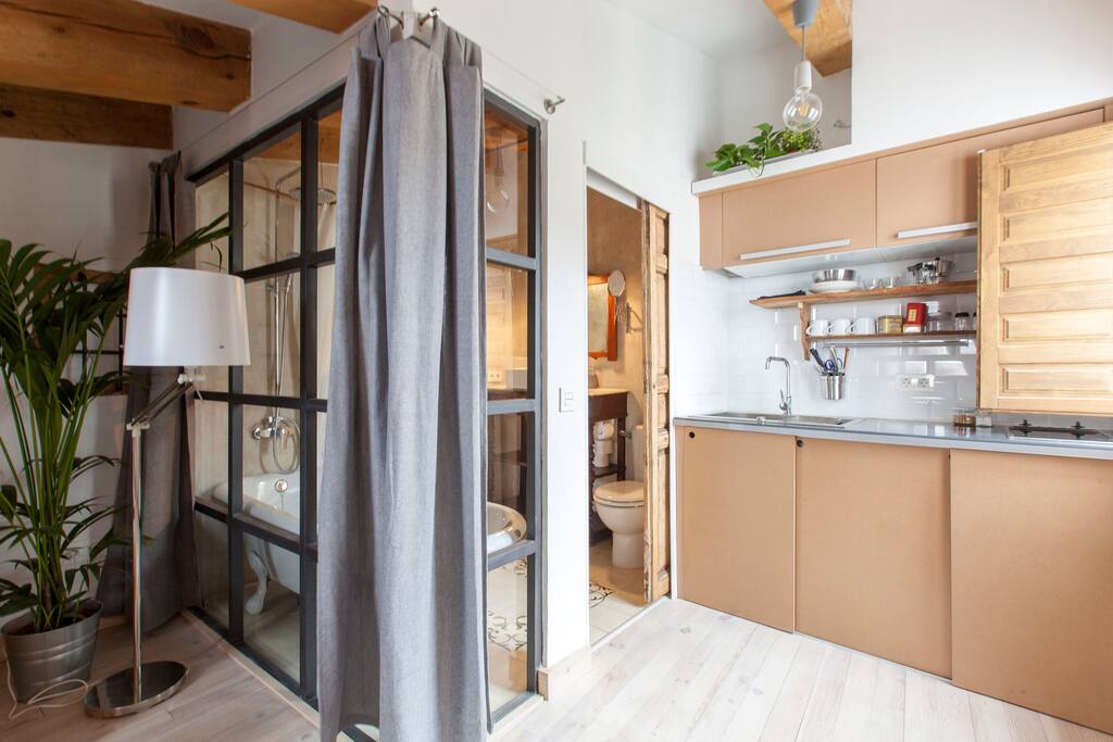 Here you can see the impressive bathroom in the left and the cozy kitchen on the right.