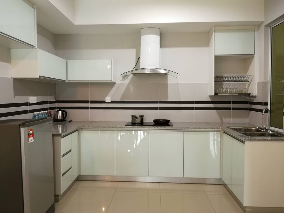 Kitchen with kettle, refrigerator, pots & pan