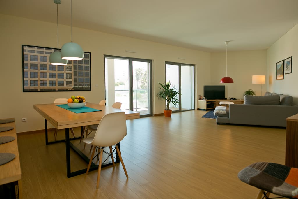 Big living room with dining area, sofa corner and easy accessible balcony