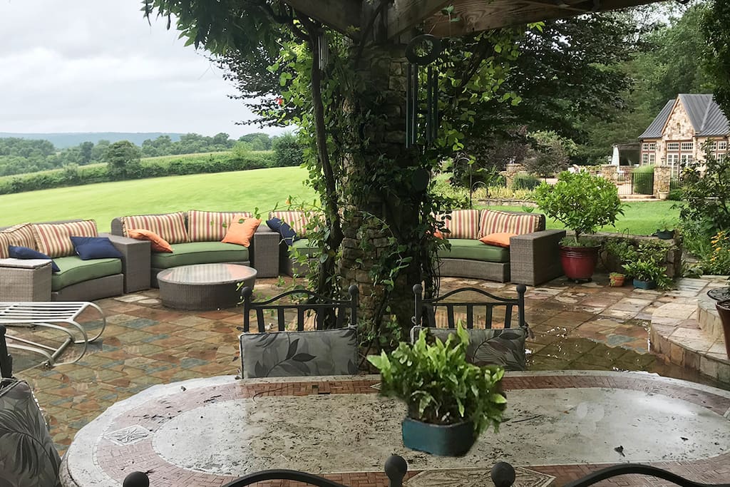 Lounge Porch with bucolic views of the mountains. Pool house is to the right.