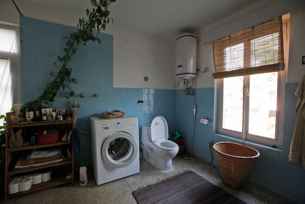 Bathroom with washing machine and hot shower facilities