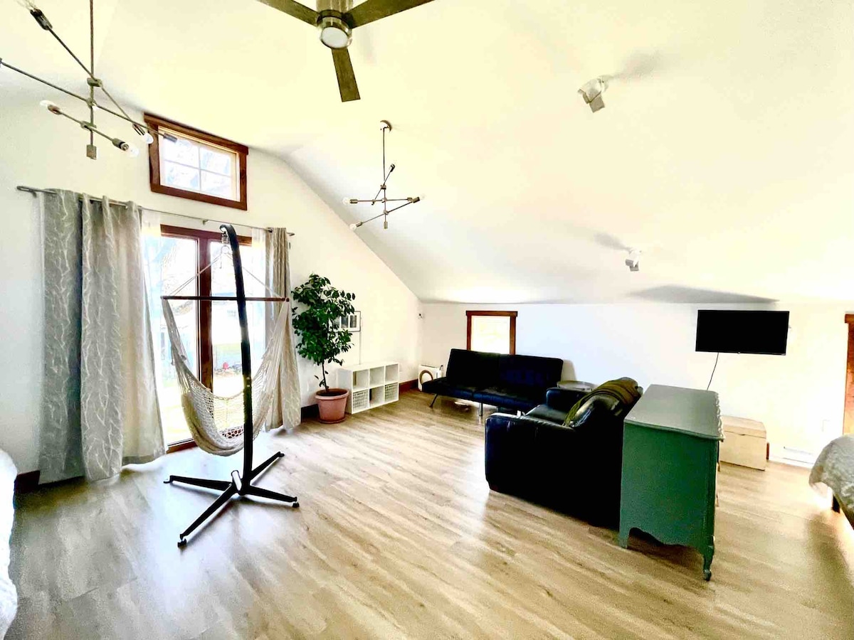 The cozy upstairs living area has an open concept with sleeping areas.