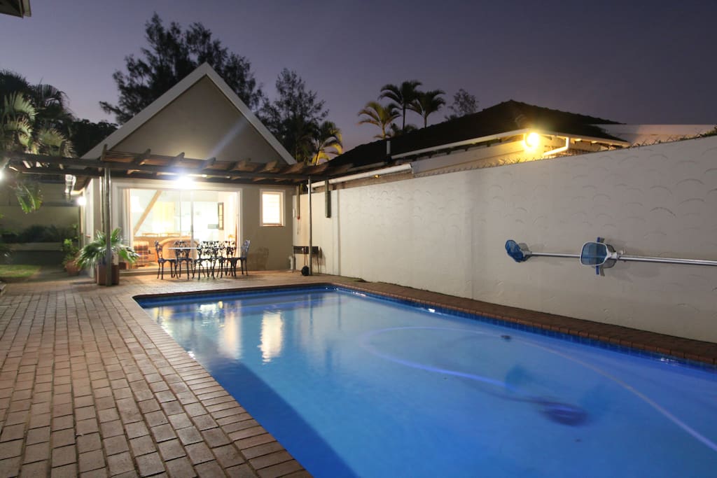 A view of the cottage from the other side of the pool.