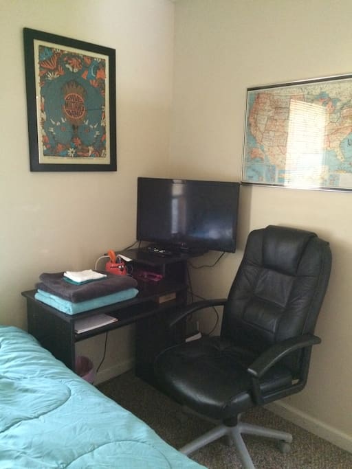 Desk and TV (new July 2016!). Alarm clock, basic office supplies, and a printer (now across the room)