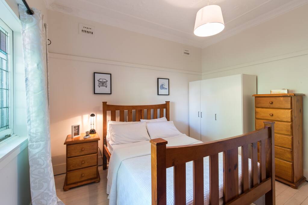 The bedroom has a double bed with lots of cupboard and storage in drawers