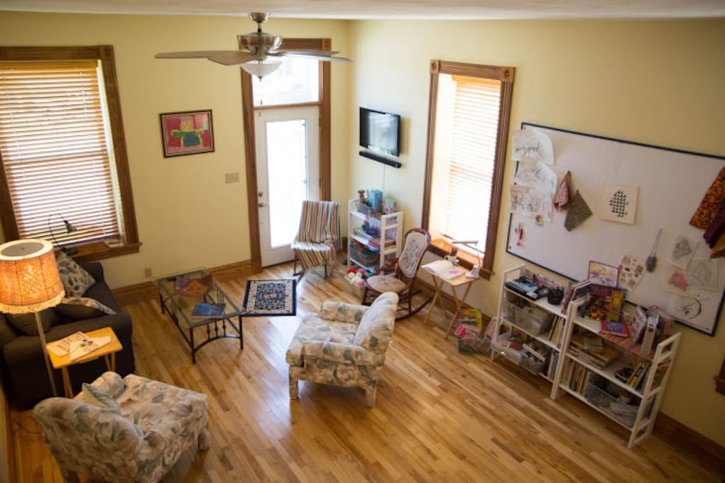 Living room with craft supplies and design wall