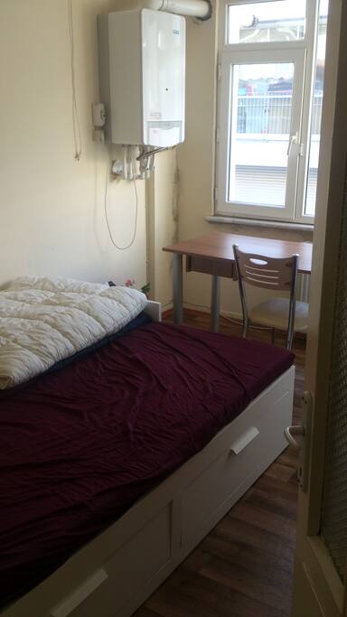 guest room with a large bed, table and a big closet to use
