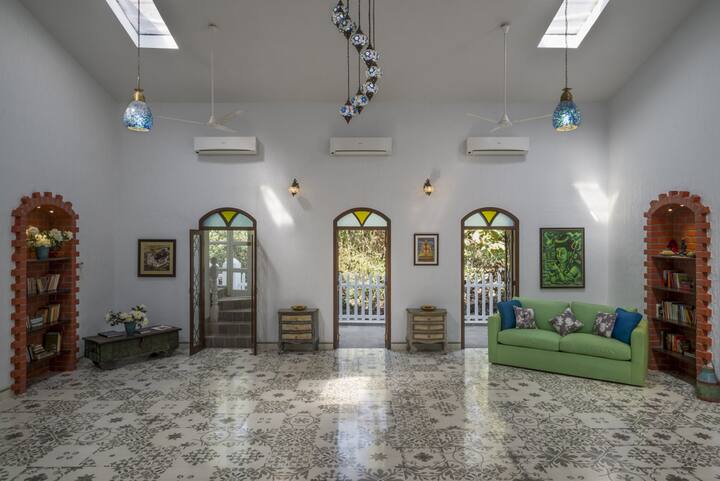 The hall in all its glory with a view of the trees and greenery at every window