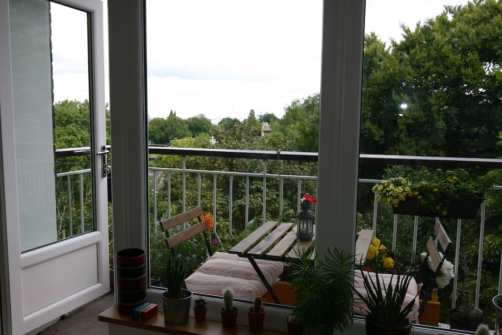 The balcony is surrounded by trees, and very private. You may even see a parakeet!