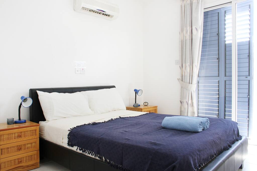 Comfortable bed with balcony overlooking the pool.