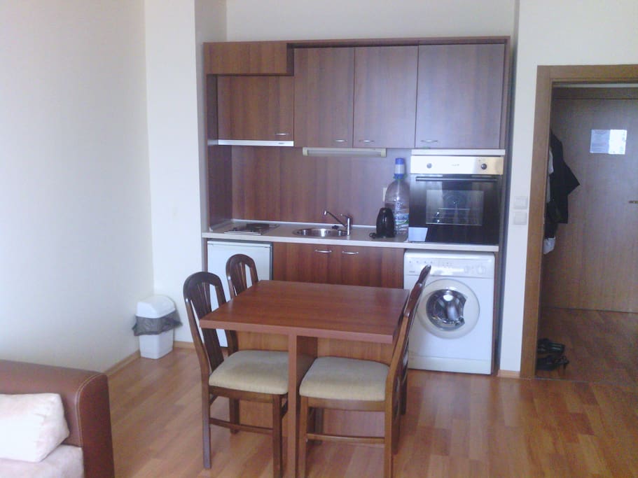 kitchen - table for 4, refrigerator, oven, washing machine.