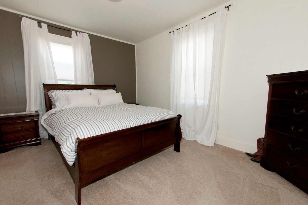 Master bedroom with sleigh bed and matching furnishings.
