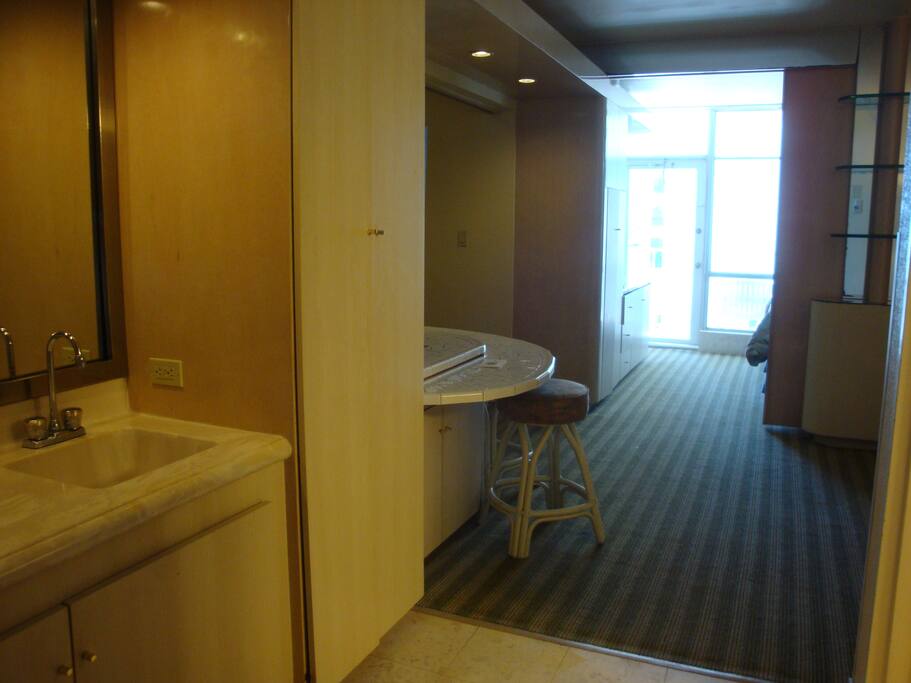 Entrance. Sink, microwave, small refrig to the left.
