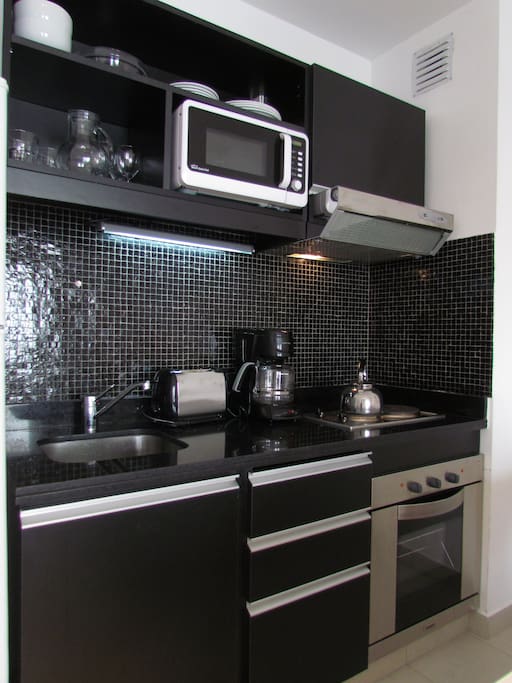 Fully equipped kitchen with new appliances and kitchenware and utensils