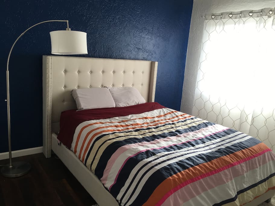 Queen sized bed in master bedroom on second floor with vaulted ceilings.
