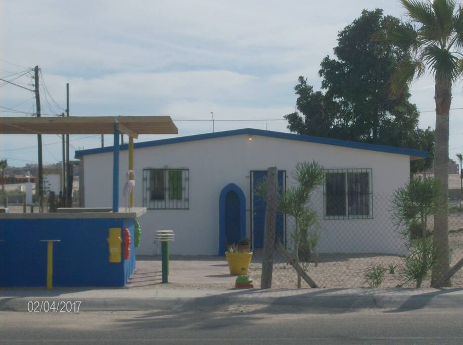 Front of Bungalow with Food Stand in Front.