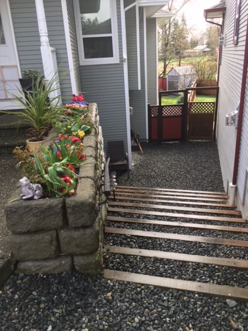 Steps from driveway to gate that leads to backyard and suite entrance. Please keep the gate closed to keep the deer out and the dog in.