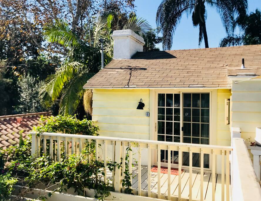 This is the ivy covered deck that leads to the entrance to your private Rooftop King Suite!