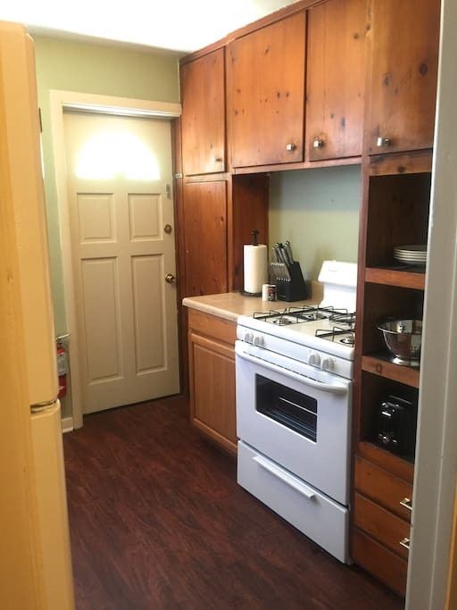 Fully equipped kitchen with stove, microwave, oven, full fridge, coffee maker, utensils, cookware etc...