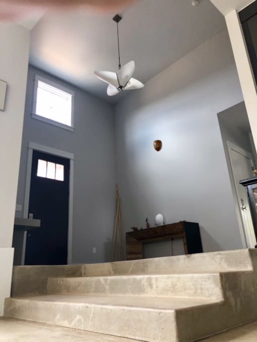 Cathedral-like entryway leads to sunken living space.