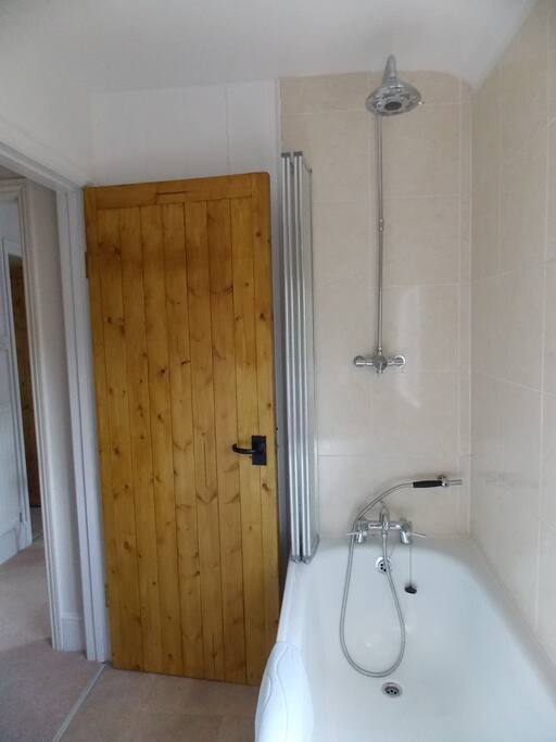 Bathroom (shower over bath) WC & sink.