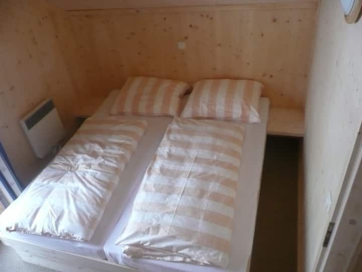 Main bedroom double bed, door to balcony and plenty of storage