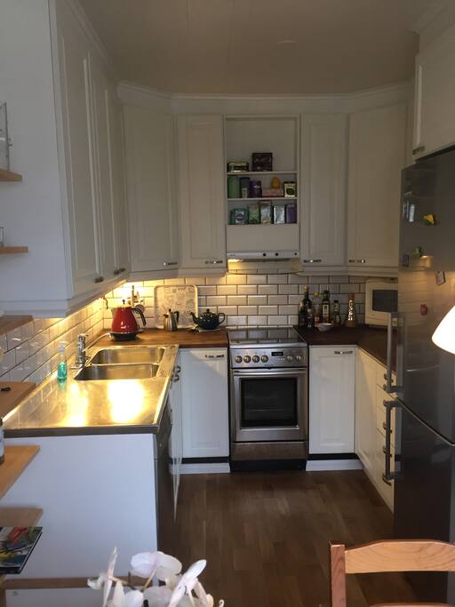 Kitchen with access to fridge, freezer, coffee maker, microwave, stove, dish washer water boiler.