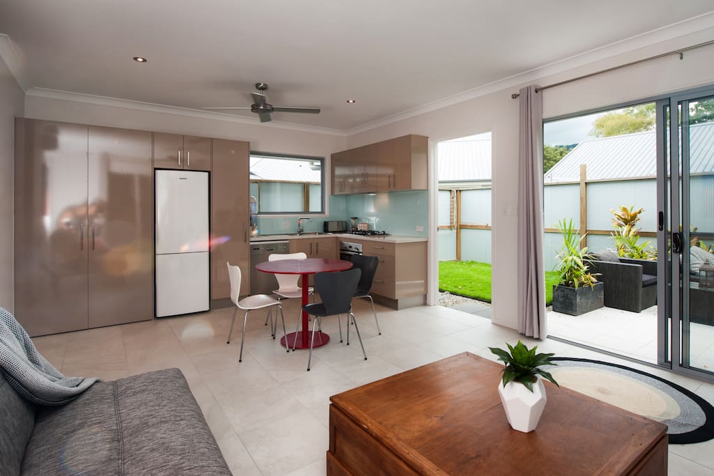 Kitchen with dishwasher and laundry in cupboard