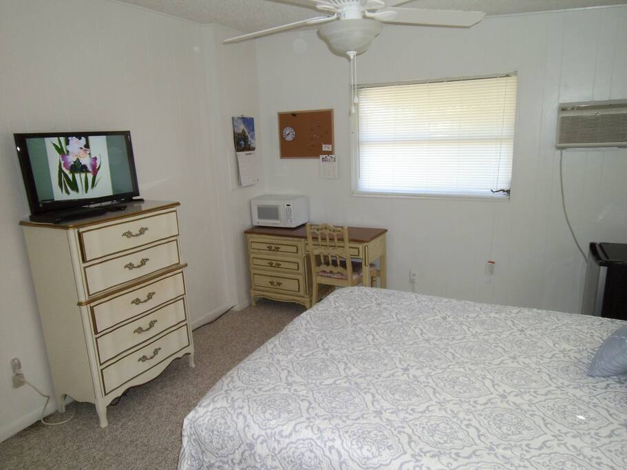 Pleasant room with AC and LCD television. coffee pot and compact refrigerator in room