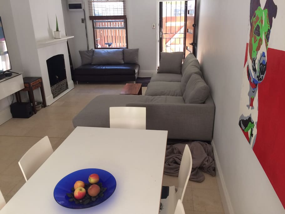 Open dining / lounge area featuring a bowl with apples...