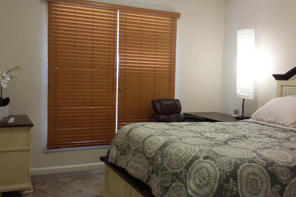 Guest room has a small study desk with comfy office chair