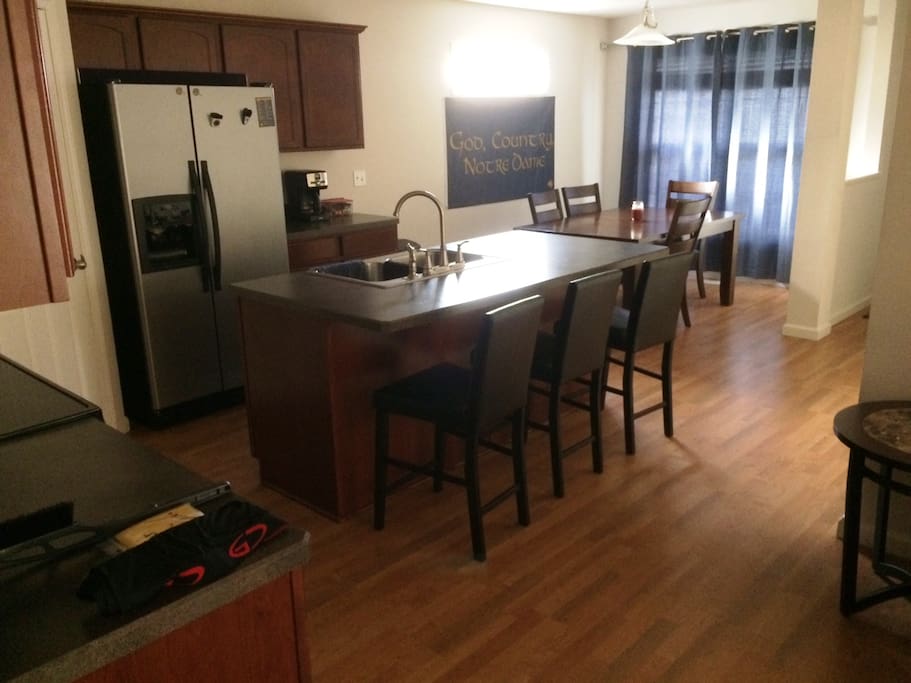 Large kitchen with all cooking supplies, large dining rom table and breakfast bar seating.