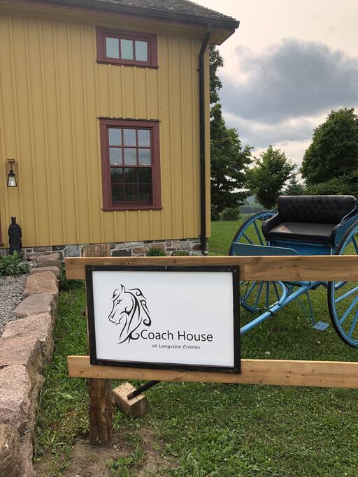 Welcome sign at Coach House and parking area