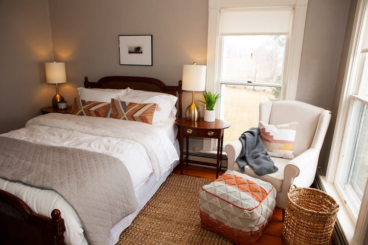 At the top of the main stairs, this queen bedroom welcomes you with a memory foam mattress, luxury linens, room darkening shades, and a seating area to take in the views.