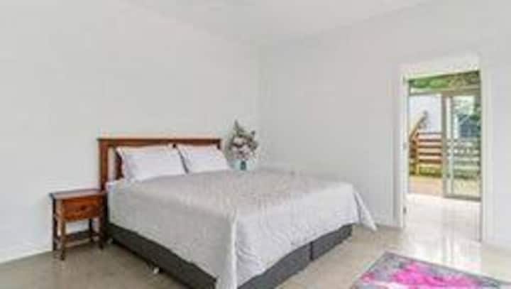 Bedroom 3 adjoining garage with king sized bed and ensuite