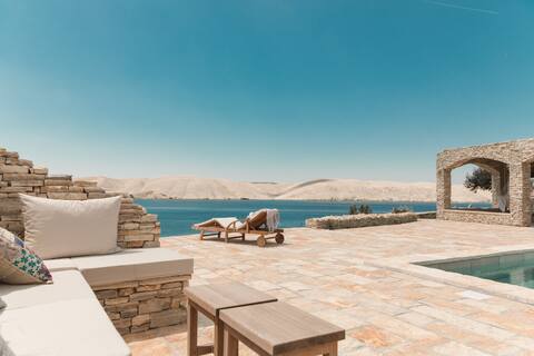 Sika: Seafront stone house with a pool