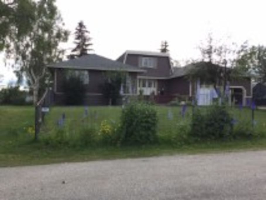 Front view of our home. Access to the apartment is to the left along the fence. Very private and well maintained all year long.