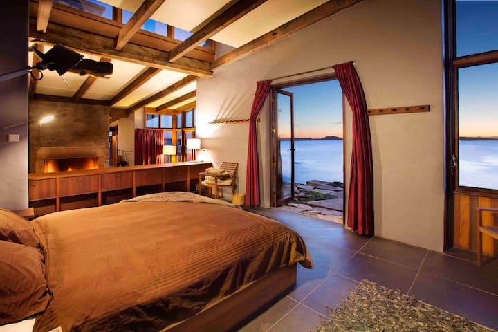 All our guest rooms have comfy king beds, custom-made all natural bedding, and open out to the sound of the ocean. 