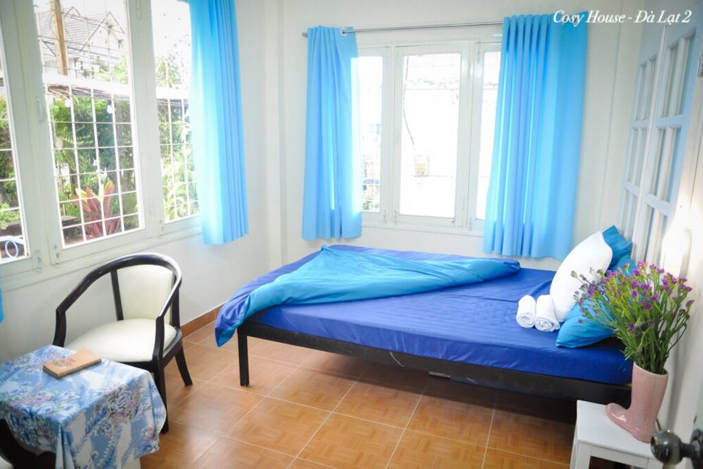 This is a bedroom with many windows and light