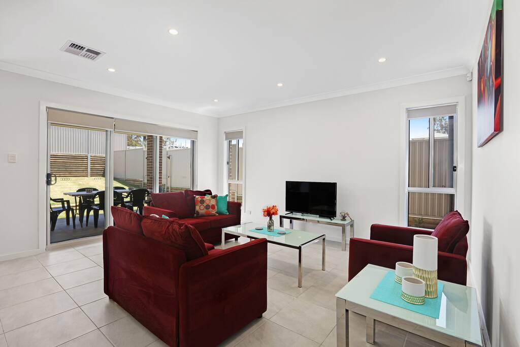 Comfortable Lounge Areas with Access to Backyard