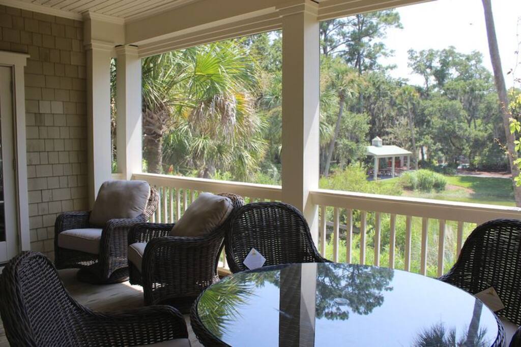 Enjoy reading or gather around the table with appetizers and cool drinks. View towards the regime's two pools.