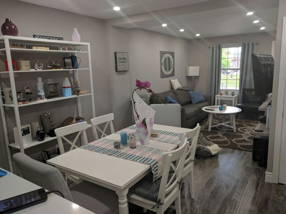Dining and living areas. Dining table pulls out to seat up to 10 people.
TV has tons of channels including Netflix