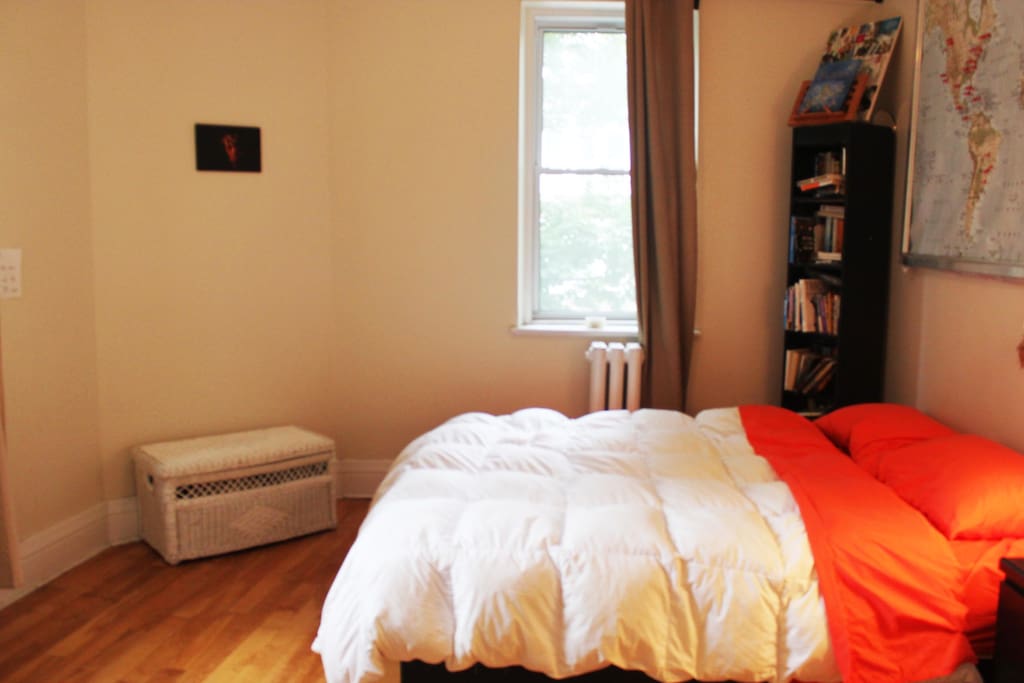 Queen-sized bedroom with two bright windows overlooking Mount-Royal.