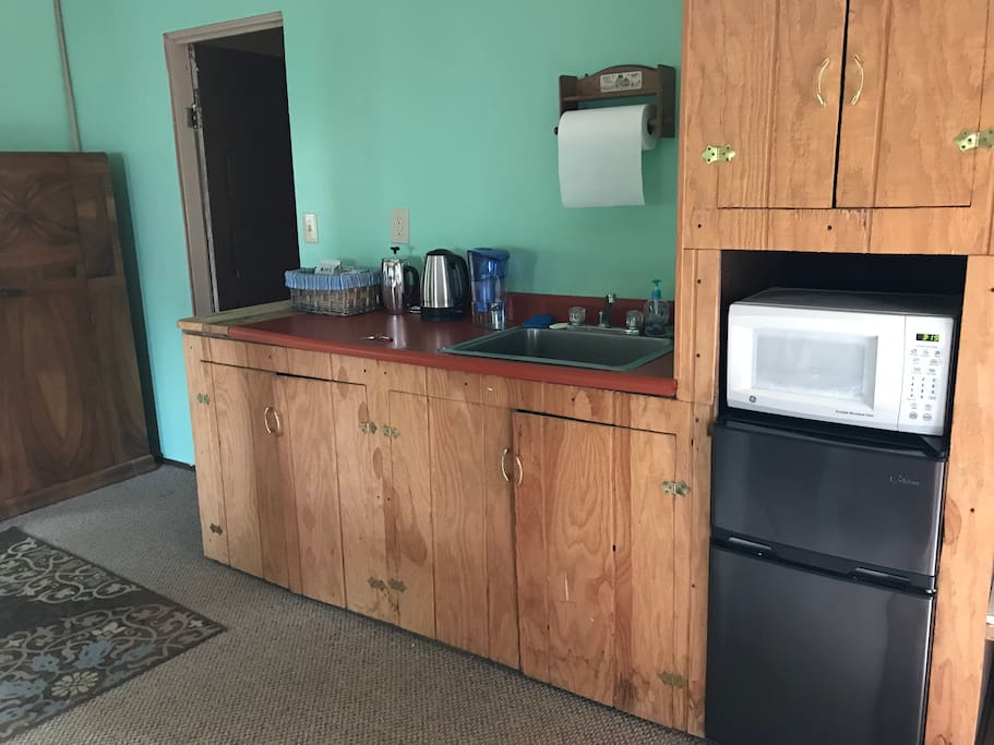 Kitchen area with sink, microwave, fridge